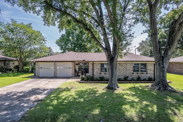 single story home featuring driveway, brick siding, a front lawn, an attached garage, and a shingled roof