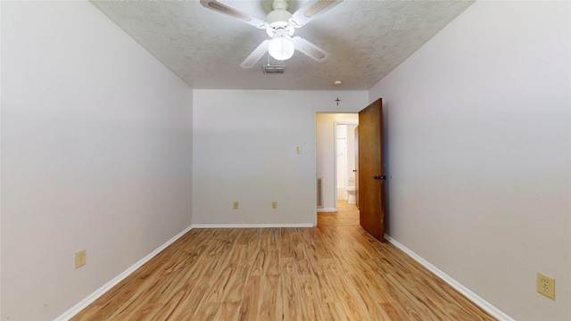 unfurnished room with baseboards, visible vents, ceiling fan, and light wood finished floors