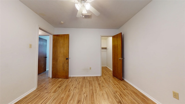 unfurnished bedroom with baseboards, visible vents, light wood-style flooring, and a closet