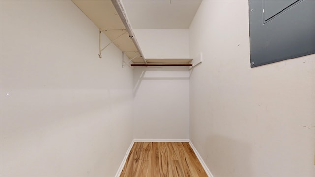 spacious closet featuring wood finished floors and electric panel