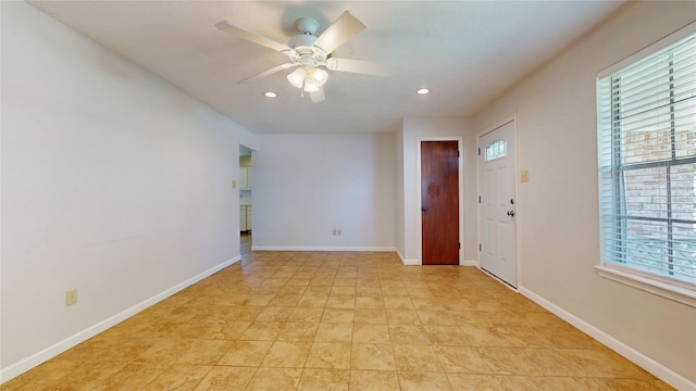 empty room with recessed lighting, a ceiling fan, and baseboards