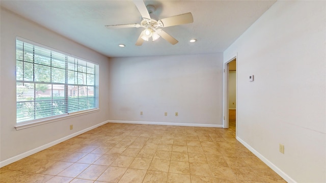 empty room featuring recessed lighting, a ceiling fan, baseboards, and light tile patterned floors