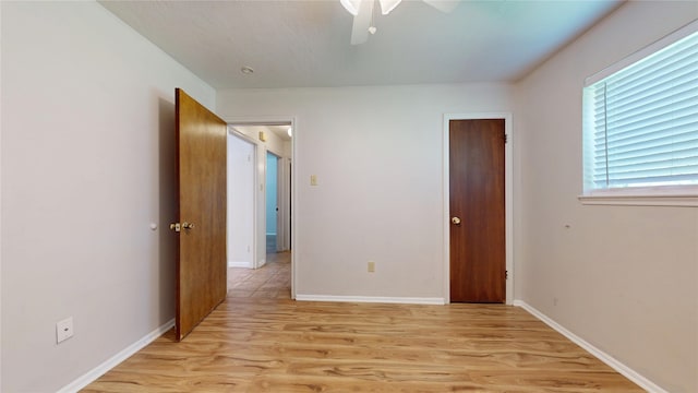 unfurnished bedroom with baseboards, a ceiling fan, and light wood finished floors