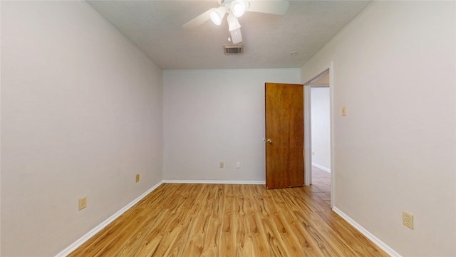 empty room with a ceiling fan, baseboards, visible vents, and light wood-type flooring