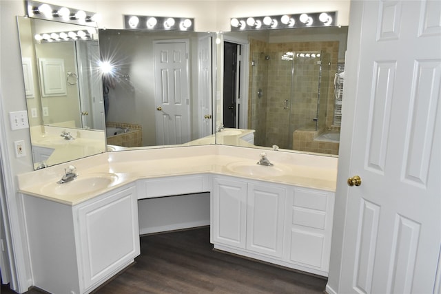 11111 Sprucedale Ct, Houston, TX 77070 - bathroom featuring double vanity, a shower stall, a sink, and wood finished floors