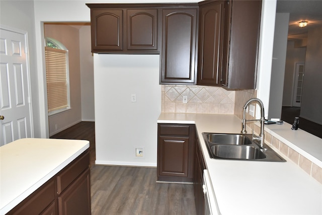 11111 Sprucedale Ct, Houston, TX 77070 - kitchen featuring dark wood-style flooring, dark brown cabinetry, light countertops, a sink, and backsplash