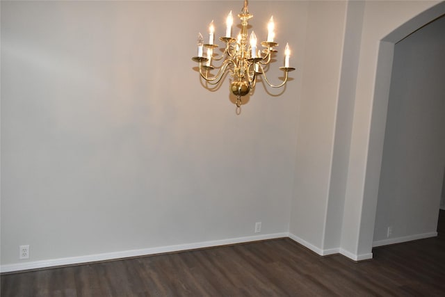 11111 Sprucedale Ct, Houston, TX 77070 - unfurnished room featuring arched walkways, baseboards, a chandelier, and dark wood-type flooring
