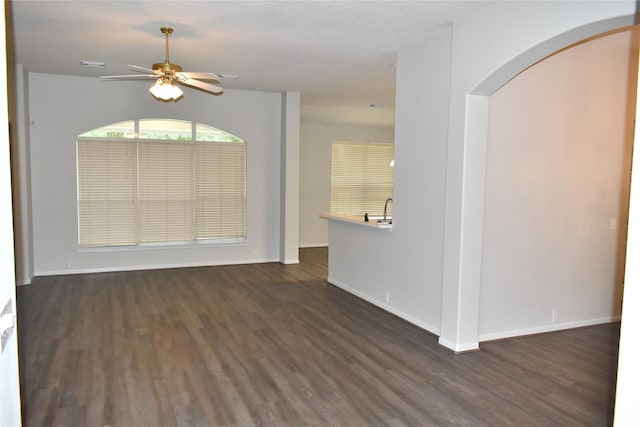 11111 Sprucedale Ct, Houston, TX 77070 - empty room with baseboards, a ceiling fan, arched walkways, and wood finished floors