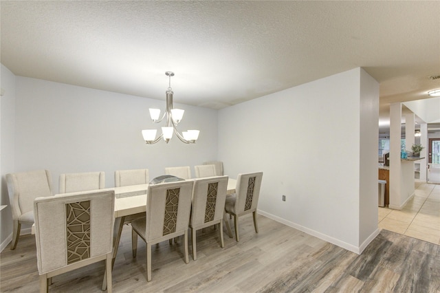 10338 E Summit Canyon Dr, Houston, TX 77095 - dining area featuring baseboards, a chandelier, visible vents, and light wood-type flooring