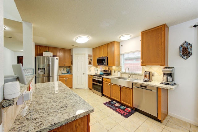 10338 E Summit Canyon Dr, Houston, TX 77095 - kitchen with a sink, appliances with stainless steel finishes, light stone countertops, and tasteful backsplash