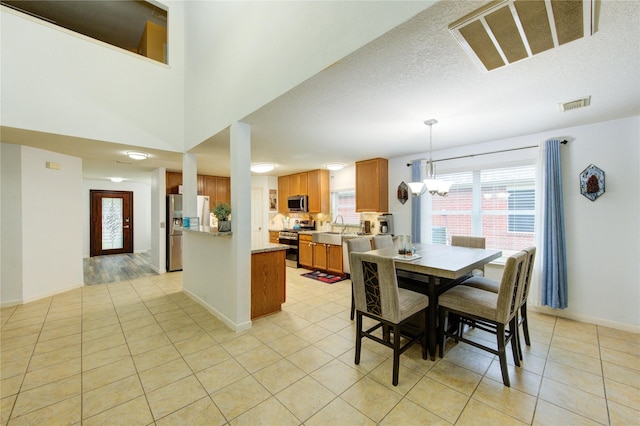 10338 E Summit Canyon Dr, Houston, TX 77095 - dining space featuring baseboards, light tile patterned flooring, and visible vents