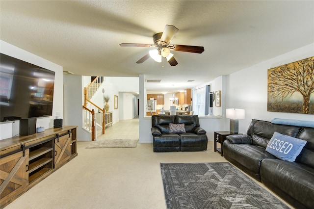 10338 E Summit Canyon Dr, Houston, TX 77095 - living room with carpet, a ceiling fan, stairs, and visible vents