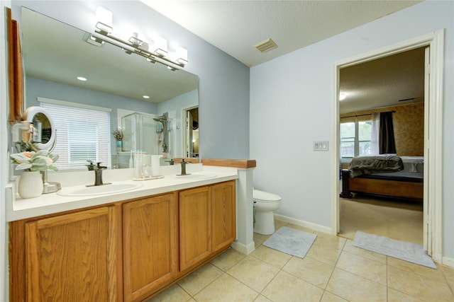 10338 E Summit Canyon Dr, Houston, TX 77095 - bathroom featuring visible vents, double vanity, connected bathroom, a shower stall, and a sink