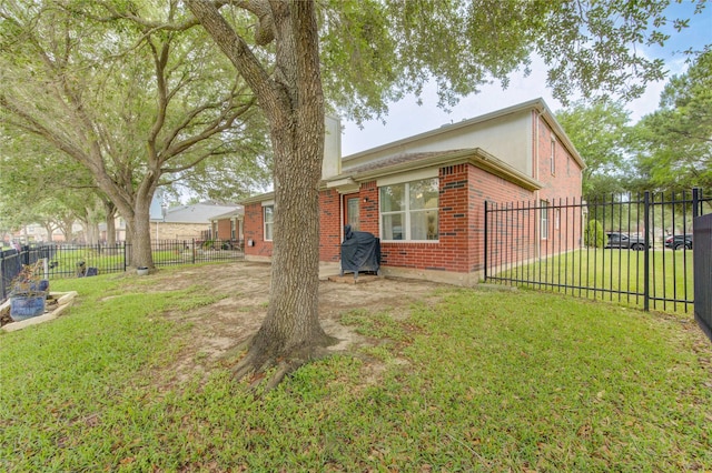 10338 E Summit Canyon Dr, Houston, TX 77095 - view of side of property with a lawn, a gate, fence private yard, and brick siding