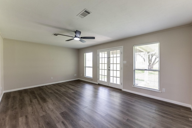 spare room with baseboards, visible vents, french doors, and dark wood-type flooring