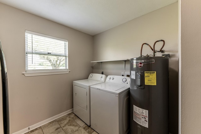 washroom featuring laundry area, baseboards, water heater, light tile patterned flooring, and washer and dryer