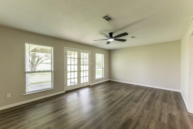 empty room with french doors, a ceiling fan, visible vents, baseboards, and dark wood-type flooring