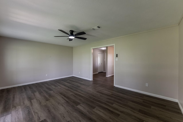 empty room with baseboards, ceiling fan, dark wood-style floors, and visible vents