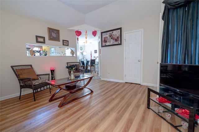 sitting room with baseboards and wood finished floors