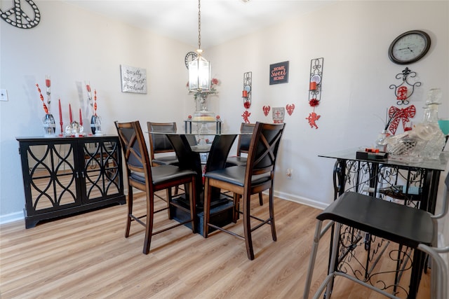 dining space featuring baseboards and wood finished floors