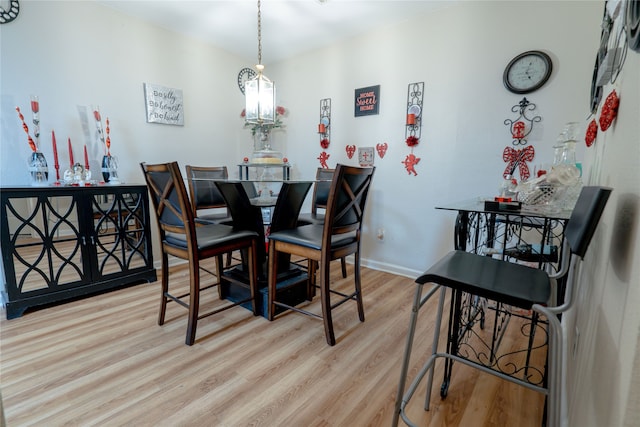 dining room with baseboards and wood finished floors