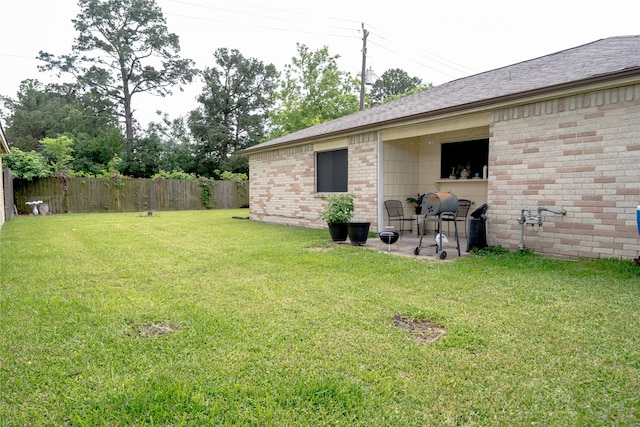 view of yard with fence and a patio area