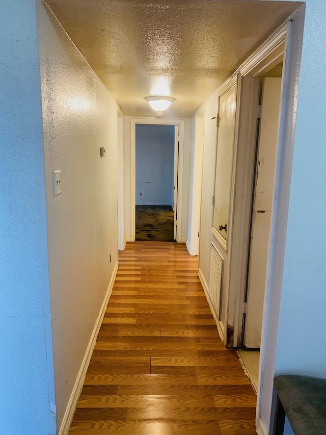 12500 Sandpiper Dr Unit 91, Houston, TX 77035 - corridor featuring baseboards, a textured ceiling, and wood finished floors