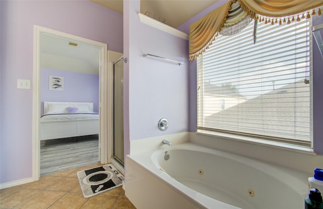 full bathroom featuring tile patterned flooring, a whirlpool tub, a stall shower, and connected bathroom