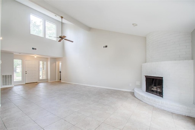 unfurnished living room with visible vents, a brick fireplace, and light tile patterned floors