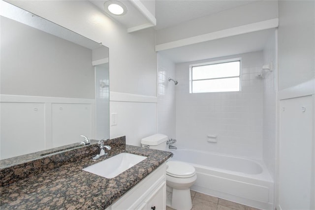 bathroom with toilet, shower / bathing tub combination, tile patterned flooring, and vanity