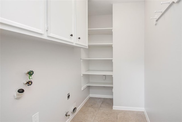 laundry room with cabinet space, light tile patterned flooring, gas dryer hookup, electric dryer hookup, and baseboards