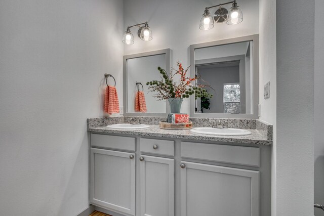 full bath with a sink and double vanity