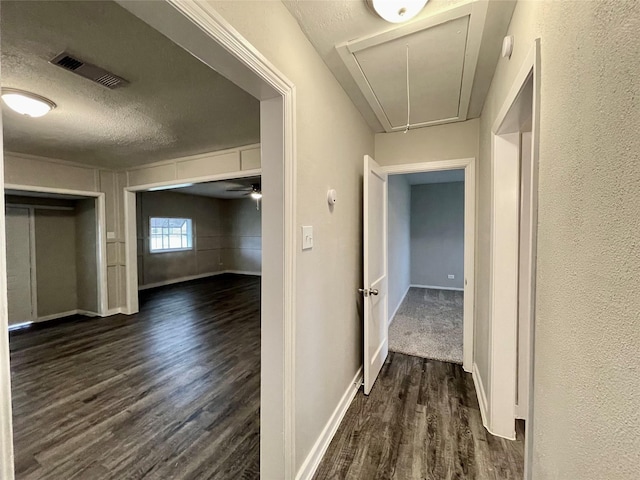 1827 Neuman St, La Marque, TX 77568 - hall featuring attic access, a textured ceiling, visible vents, dark wood finished floors, and baseboards