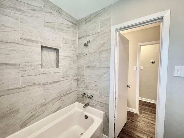 1827 Neuman St, La Marque, TX 77568 - full bathroom featuring baseboards, wood finished floors, and bathing tub / shower combination