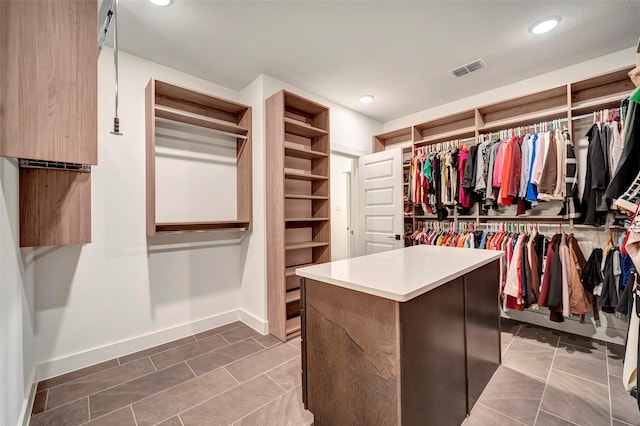 spacious closet featuring visible vents and tile patterned flooring
