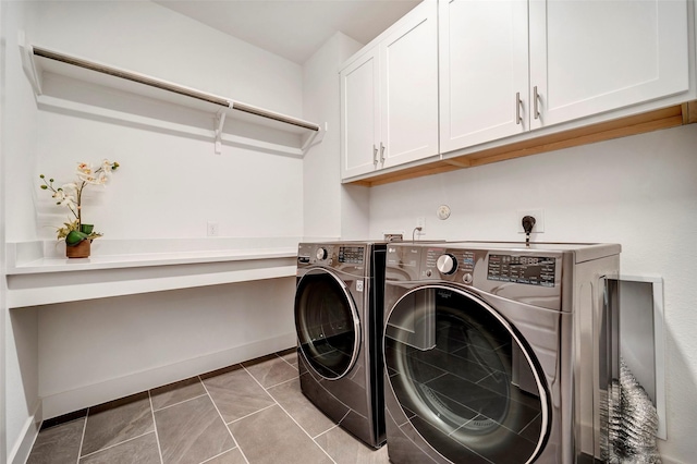 laundry area with cabinet space, baseboards, and washer and clothes dryer