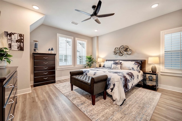 bedroom featuring visible vents, baseboards, ceiling fan, and light wood-type flooring