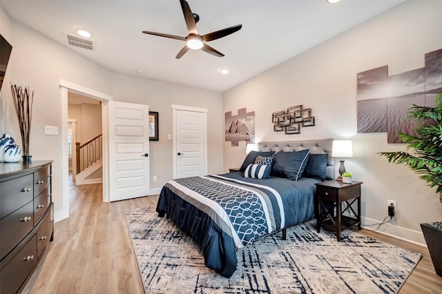 bedroom with recessed lighting, baseboards, light wood-type flooring, and visible vents