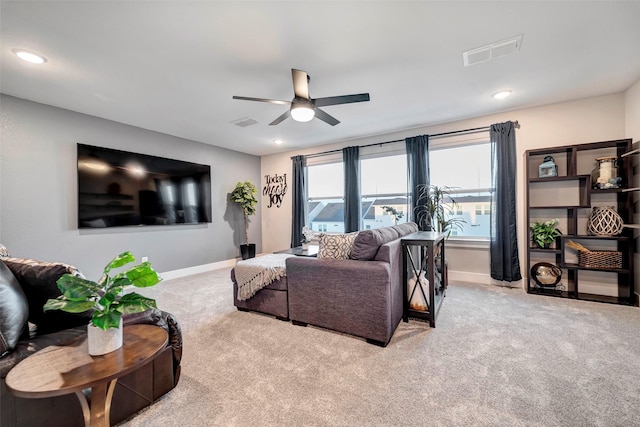 living area with carpet floors, a ceiling fan, baseboards, and visible vents