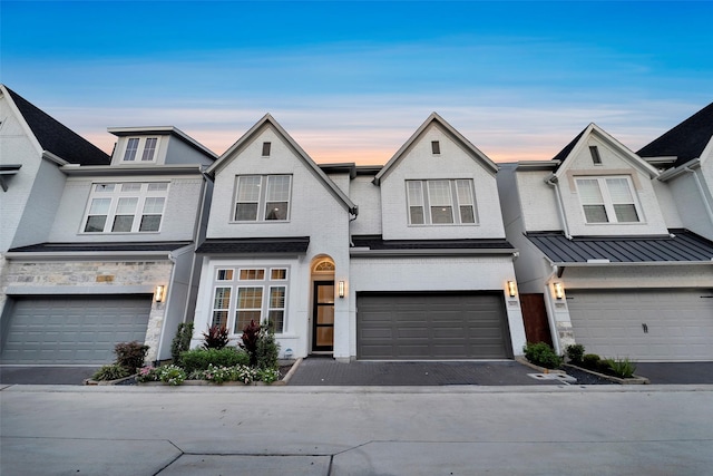 view of property with an attached garage and driveway