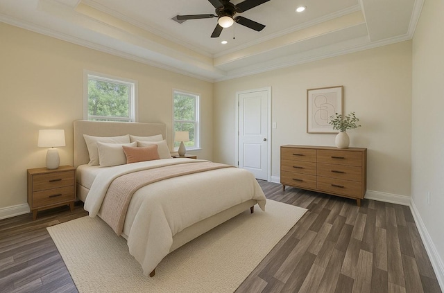 bedroom featuring baseboards, a raised ceiling, ornamental molding, and dark wood-type flooring