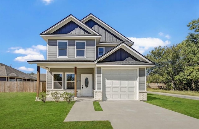 craftsman-style home with fence, a front lawn, board and batten siding, a porch, and driveway