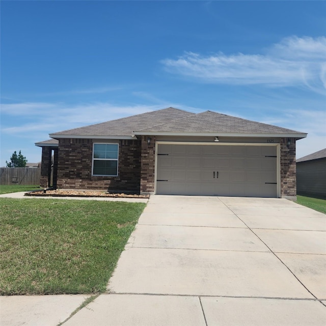 view of front of home featuring an attached garage, brick siding, a front yard, and concrete driveway