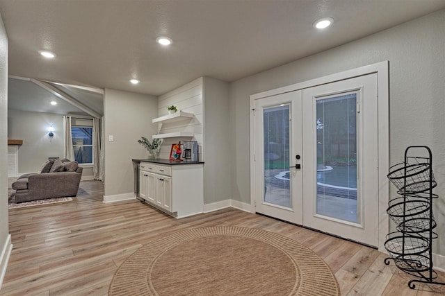 doorway featuring french doors, light wood-type flooring, baseboards, and recessed lighting