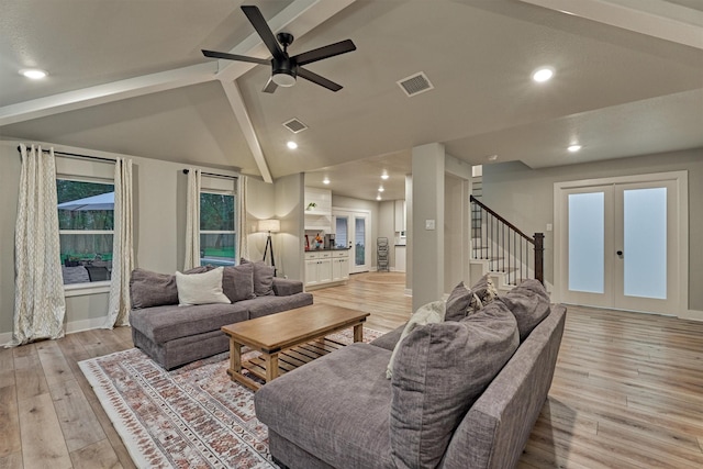 living area with french doors, ceiling fan, stairs, light wood-type flooring, and baseboards