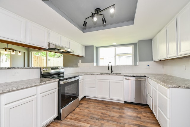 kitchen featuring decorative backsplash, a sink, appliances with stainless steel finishes, and under cabinet range hood