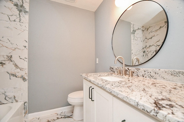 bathroom with toilet, marble finish floor, baseboards, and vanity