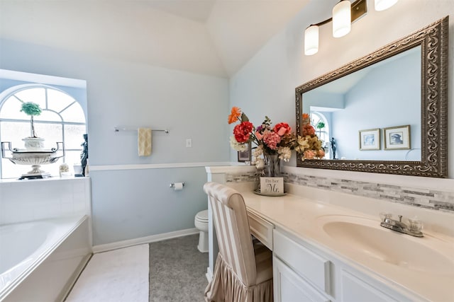 full bathroom with healthy amount of natural light, lofted ceiling, vanity, toilet, and a bath