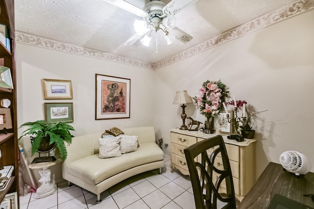 sitting room with a ceiling fan and light tile patterned floors