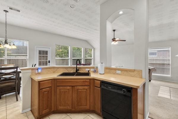4526 Cannongate Dr, Spring Branch, TX 77373 - kitchen with black dishwasher, brown cabinetry, pendant lighting, light countertops, and a chandelier